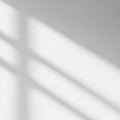 Soft, blurred shadows of horizontal lines are cast on a smooth white surface, sugges Royalty Free Stock Photo