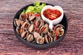 Soft-boiled blood cockles shell served with spicy sauce.
