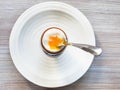 Soft-boiled brown egg with spoon in cup on plate Royalty Free Stock Photo