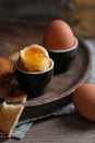Soft boiled chicken eggs with toasted bread on wooden table Royalty Free Stock Photo