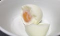 Soft-boiled egg in white bowl.