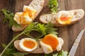 Soft boiled eggs broken open on baguettes Royalty Free Stock Photo