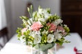 Soft bridal bouquet of fresh flowers in glass vase on celebratory table closeup, blurred background. Elegant attribute Royalty Free Stock Photo