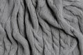A soft, cable-knit fabric texture background in cozy heather gray. The intricate, twisting knit Royalty Free Stock Photo