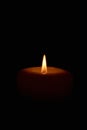 Soft candle light in total darkness with copy space Royalty Free Stock Photo