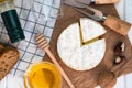 Soft cheese Camembert, honey, nuts and bottle of wine on the table for dinner. Close-up. Top view. Selective focus Royalty Free Stock Photo