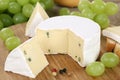 Soft cheese like Camembert or Brie on a wooden board Royalty Free Stock Photo