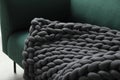 Soft chunky knit blanket on sofa indoors, closeup Royalty Free Stock Photo