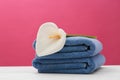 Soft clean towels with beautiful flower on table Royalty Free Stock Photo