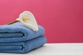 Soft clean towels with beautiful flower on table Royalty Free Stock Photo