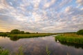 Soft clouds over calm water in the Dutch countryside