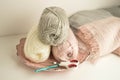 Soft colored woolen balls with crochet hook and scissors for handicraft close up