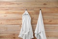 Soft comfortable bathrobe and towel hanging on wall