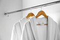 Soft comfortable bathrobes hanging on in closet Royalty Free Stock Photo