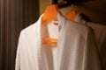 Soft comfortable bathrobes hanging on rack in closet Royalty Free Stock Photo