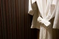 Soft comfortable bathrobes hanging on rack in closet Royalty Free Stock Photo