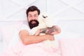 Soft cotton bedclothes. Bearded man relaxing. Circadian rhythm is natural internal process that regulates sleep wake