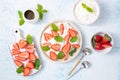 Soft cream cheese or organic curd with fresh strawberries and mint leaves top view Royalty Free Stock Photo