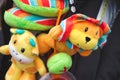 Soft cuddly toys hanging from a baby`s pushchair