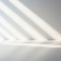 Soft, diagonal shadows cast across a smooth, white surface, creating a pattern of light Royalty Free Stock Photo