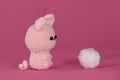 Soft DIY toy made of natural cotton and wool. Crocheted cat, handmade art. Amigurumi one cute little kitten sitting on