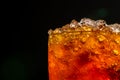 Soft drink with crushed ice cubes in glass isolated on dark back Royalty Free Stock Photo
