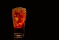 Soft drink with crushed ice cubes in glass isolated on dark background with copy space. There is a drop of water on glass Royalty Free Stock Photo