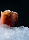 Soft drink with crushed ice cubes in glass put on pile of ice cu Royalty Free Stock Photo