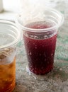 Soft drink and ice in the disposable plastic glasses Royalty Free Stock Photo