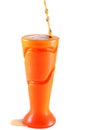 Soft drink or juice spilling out of a plastic vase