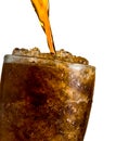 Soft drink pouring to glass with ice isolated on white background with clipping path and copy space. There is a drop of water on Royalty Free Stock Photo