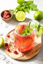 Soft drinks, healthy beverage. Refreshing summer glasses drink raspberry with mint lime and ice. Royalty Free Stock Photo
