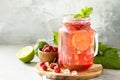 Soft drinks, healthy beverage. Refreshing summer glasses drink raspberry with mint lime and ice on a stone table. Copy space. Royalty Free Stock Photo