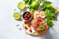 Soft drinks, healthy beverage. Refreshing summer glasses drink raspberry with mint lime and ice on a stone table. Royalty Free Stock Photo