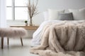 a soft faux fur thrown over a stylish modern bed