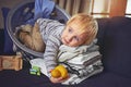 So soft it feels like a teddy bear. an adorable little boy curled up with a basket full of clean laundry. Royalty Free Stock Photo