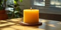The soft flicker of a bright orange candle on a surface casts mesmerizing shadows in the warm evening light Royalty Free Stock Photo