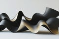 soft flowing forms in black and gold, continuously undulating and creating a visually dynamic scene