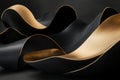soft flowing forms in black and gold, continuously undulating and creating a visually dynamic scene