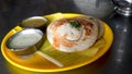 Soft and fluffy set dosas were served on a banana leaf in a hotel.