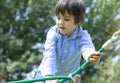 Soft focus of active kid climbing rope in the playground, High key light portrait Child enjoying activity in a climbing adventure Royalty Free Stock Photo