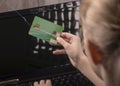 soft focus, bank card, hook. the child pays for the purchase using the card. scammers are trying to steal money from the card
