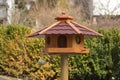 Soft focus of a bird feeder house with bird food at a park Royalty Free Stock Photo