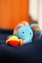 Soft focus of a blue elephant stuffed toy with a colorful ball on its trunk