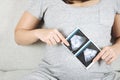 Soft focus and blurry of happy pregnant woman sitting on sofa at