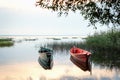 Soft focus of boats on lake standing by shore in sunset light Royalty Free Stock Photo