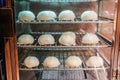 Soft focus chinese pork bun or steamed dumpling in steam cabinet warming for sale ready to eat in mini mart , Chinese food Royalty Free Stock Photo