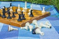 Soft focus classic chess desk on background and black and white falling figures on foreground in blue carpet texture