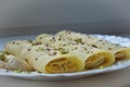Soft focus close up of 3 crepes pancakes with peanut butter and bananas topped with chocolate and cocos shavings and pistachios Royalty Free Stock Photo