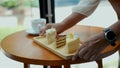 Waitress serve bakery to young muslim woman in coffee shop Royalty Free Stock Photo